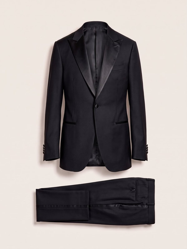 A black tuxedo with satin lapels, laid flat.